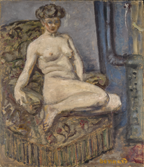 Nu au fauteuil près du poêle